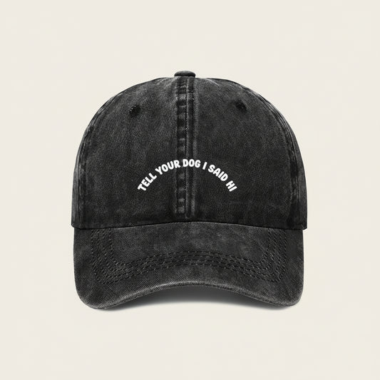 Black cap with white text 'Tell your dog I said hi' on a white background