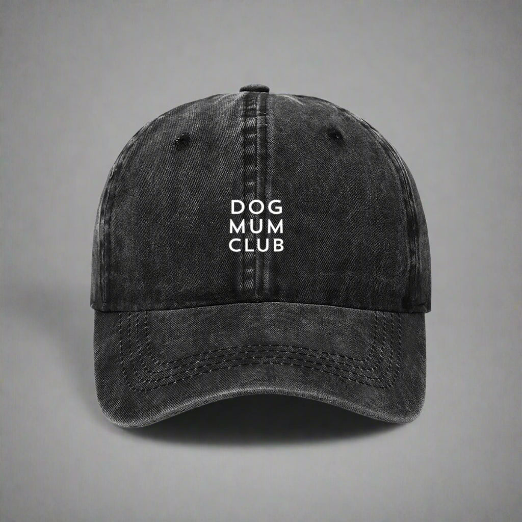 Black distressed cap with 'DOG MUM CLUB' text on a gray background