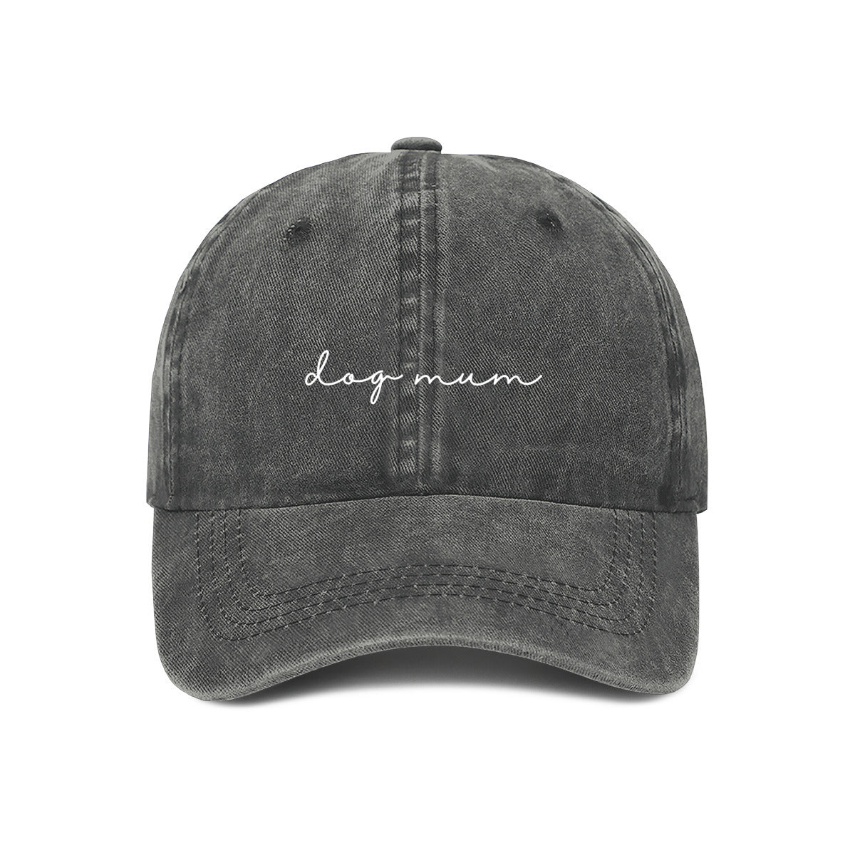 A grey baseball cap with the text 'dog mum' embroidered on the front, held up against a wall.