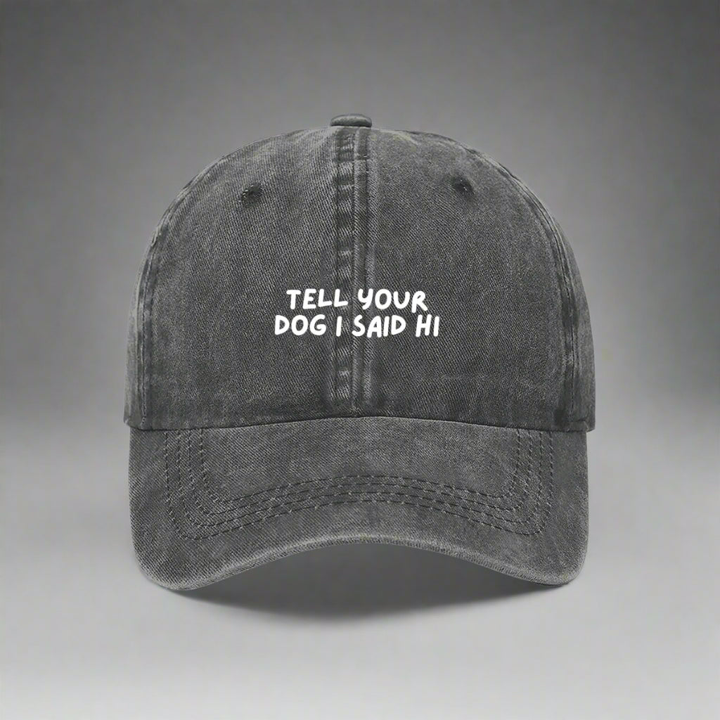 grey denim baseball cap with the text 'TELL YOUR DOG I SAID HI' embroidered on the front.