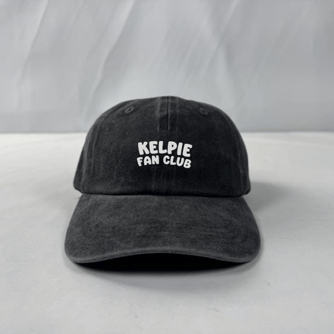 Black cap with 'Kelpie Fan Club' text on a white background