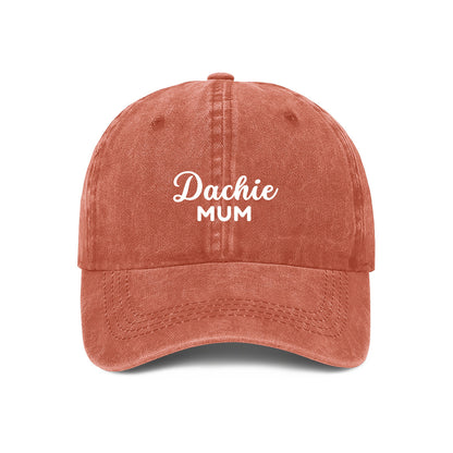 Orange baseball cap with DACHIE MUM embroidered on the front
