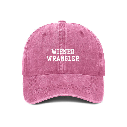 Pink denim baseball cap with 'WIENER WRANGLER' text embroidered on the front.