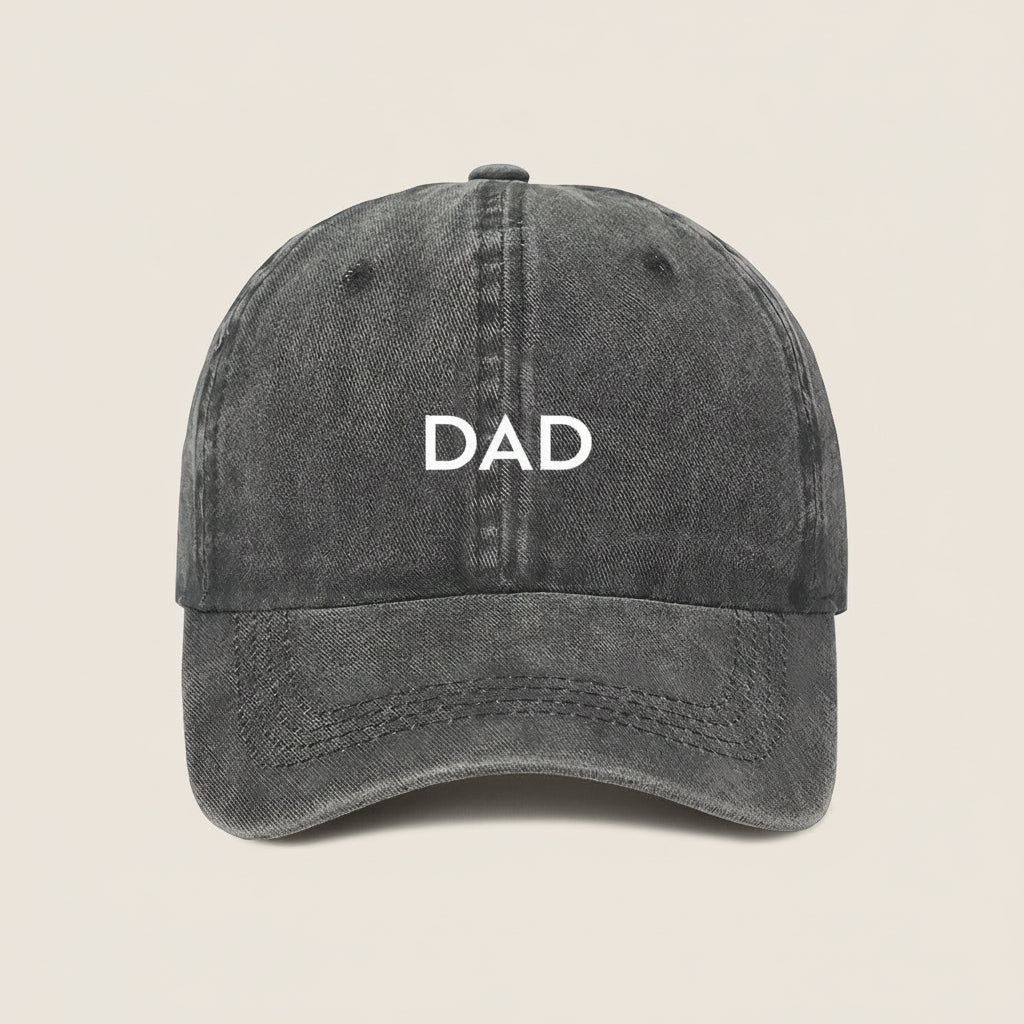 Black cap with 'DAD' embroidered on a white background