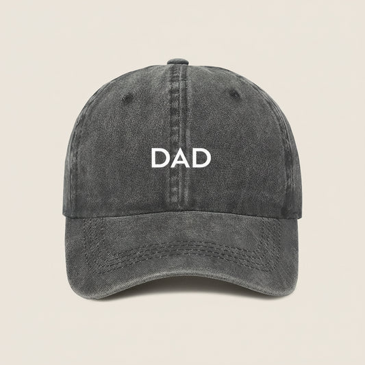Black cap with 'DAD' embroidered on a white background