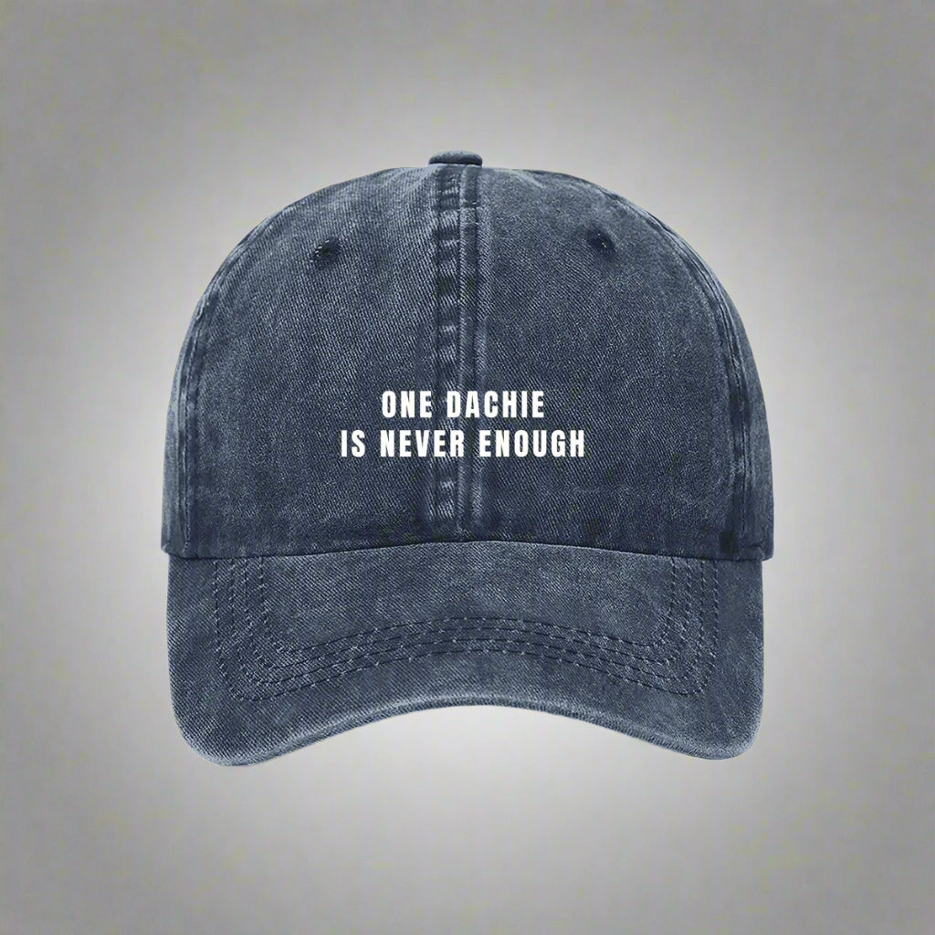 A blue denim baseball cap with the text 'ONE DACHIE IS NEVER ENOUGH' printed in white on the front.