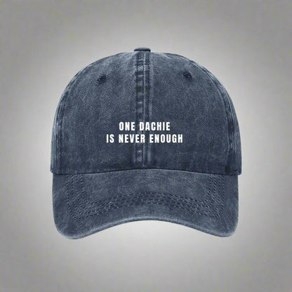 A blue denim baseball cap with the text 'ONE DACHIE IS NEVER ENOUGH' printed in white on the front.