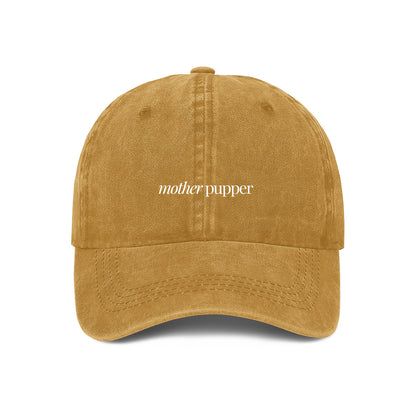 yellow denim cap with the text 'mother pupper' embroidered on the front, 
