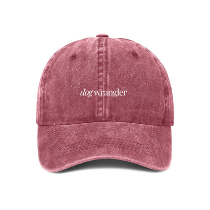 maroon baseball cap with 'dog wrangler' text embroidered on the front.