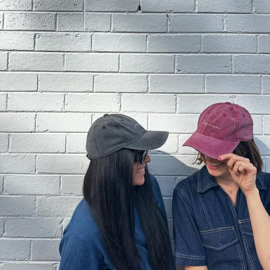 two women wearing cute caps that say "dog mum" one i wine red and one is grey. The best gift ideas for dog mums in australia