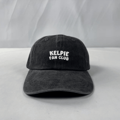 Black cap with 'Kelpie Fan Club' text on a white background