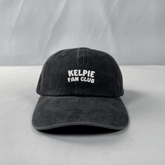 Black cap with 'Kelpie Fan Club' text on a white background