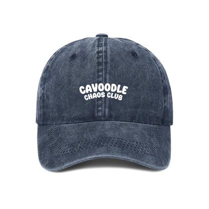 Navy blue cap with 'Cavoodle Chaos Club' text on a white background