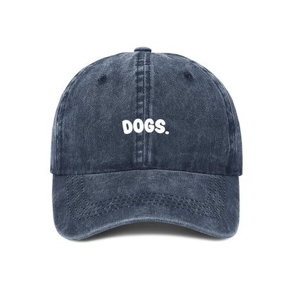 Navy blue cap with 'DOGS.' text on a white background