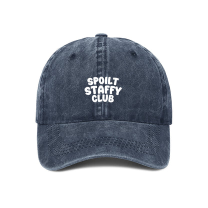 Navy blue cap with 'Spoilt Staffy Club' text on a white background