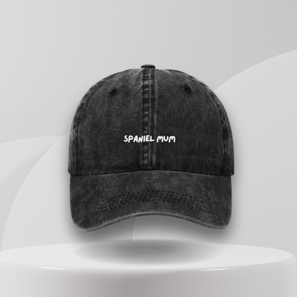 A black denim cotton cap with 'SPANIEL MUM' text embroidered on the front, 