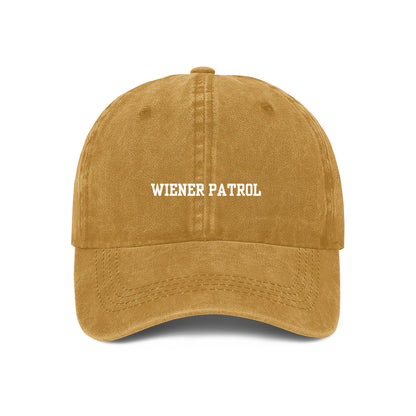A yellow embroidered baseball cap with 'WIENER PATROL' text in white on the front.